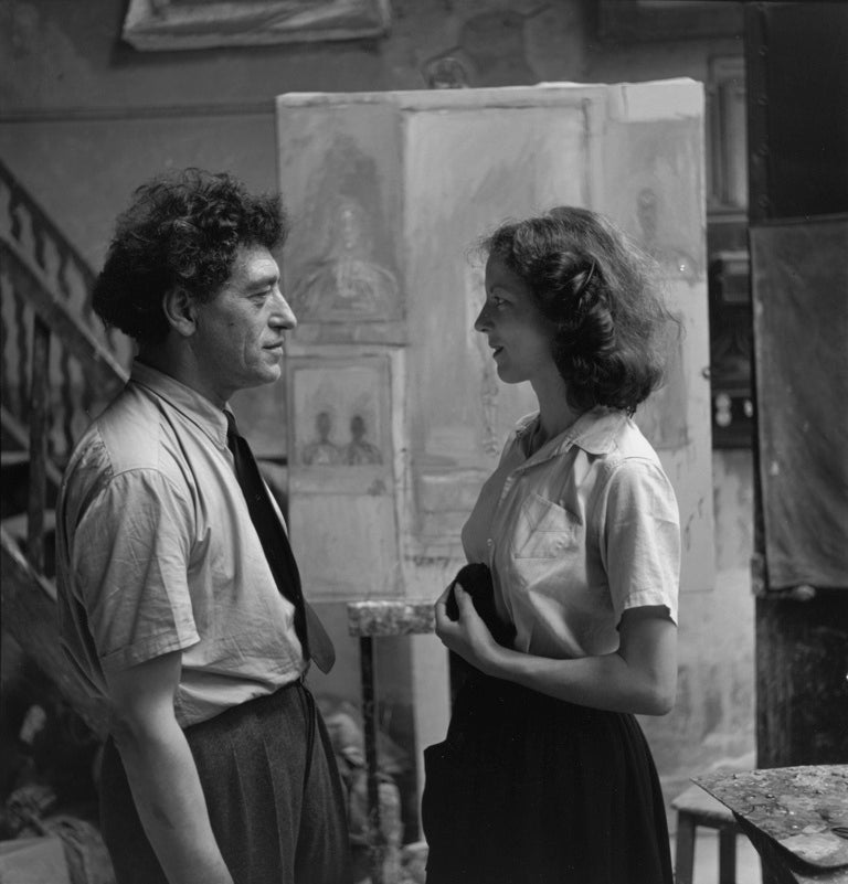 Artist and companion in a studio, black and white photograph