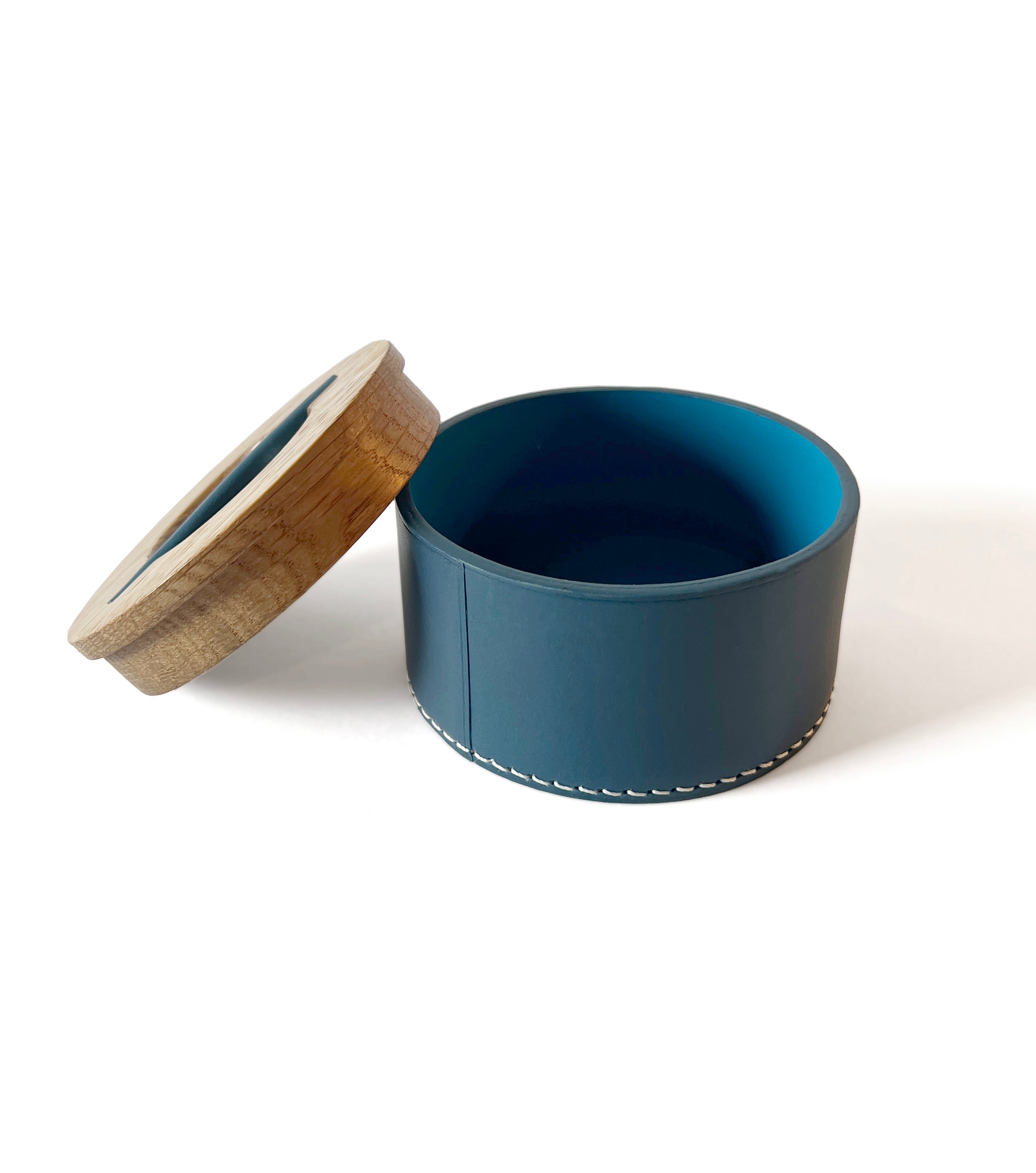 Blue container with wooden lid on a white background