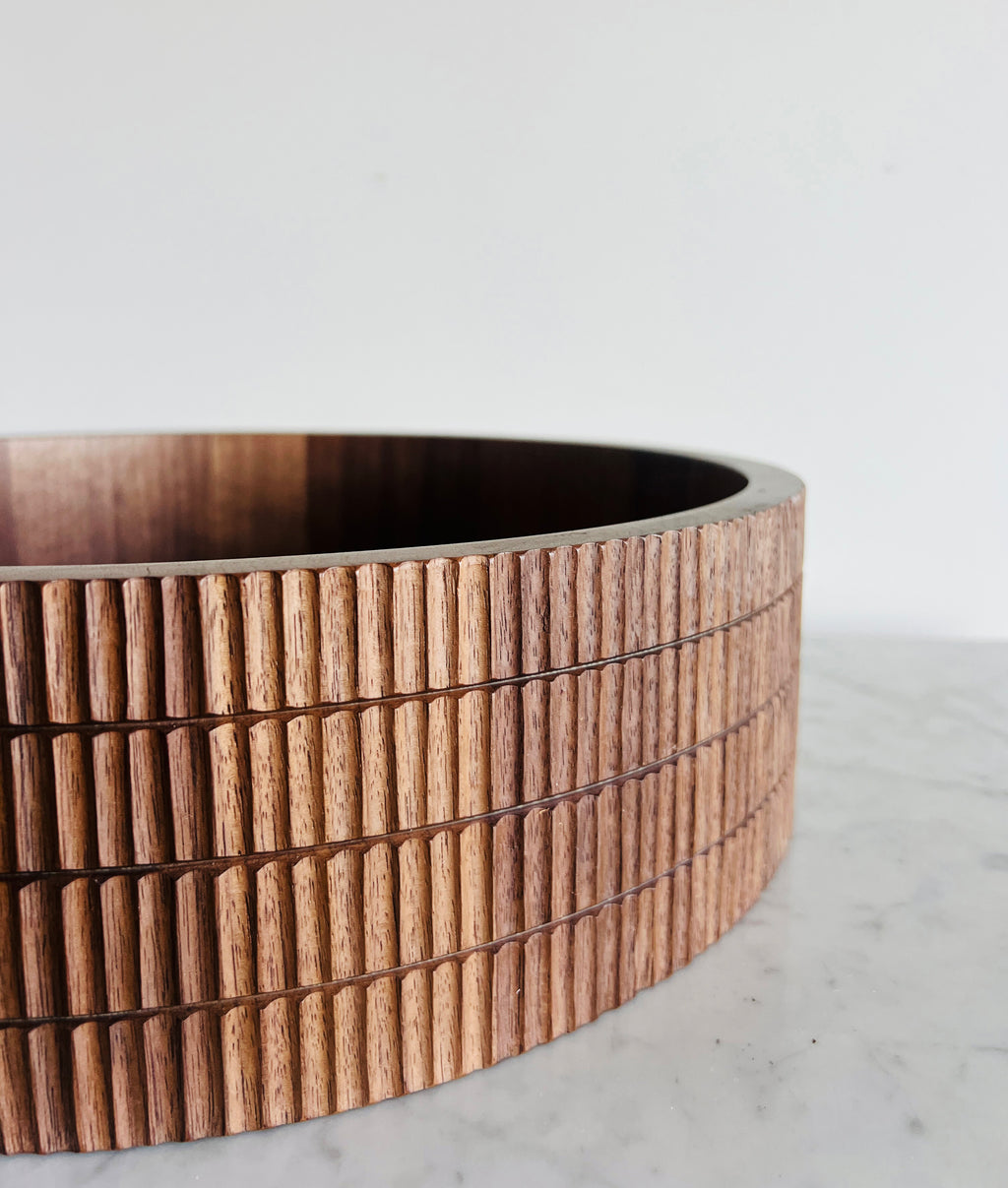 Wooden bowl with a ribbed texture on a white background